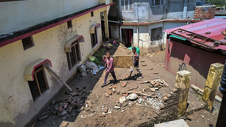 <div class="paragraphs"><p>Residents engaged in clearing debris in a landslide-affected village in Uttarakhand. </p></div>