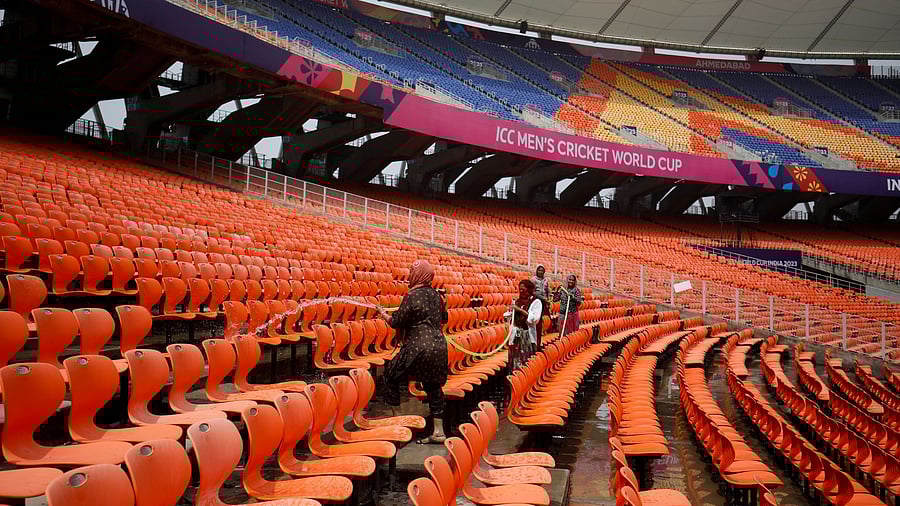 <div class="paragraphs"><p>Workers clean the seats in the stands at Narendra Modi Stadium, ahead of ICC Men's Cricket World Cup match, in Ahmedabad, India.</p></div>
