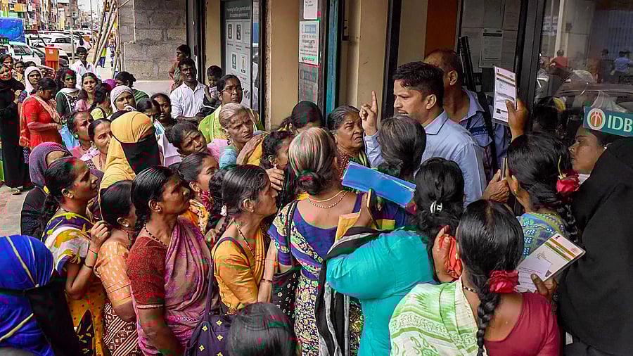 <div class="paragraphs"><p>Women wait in queues at a bank to apply for the Karnataka government's Gruha Lakshmi scheme, in Chikmagalur, Karnataka.</p></div>