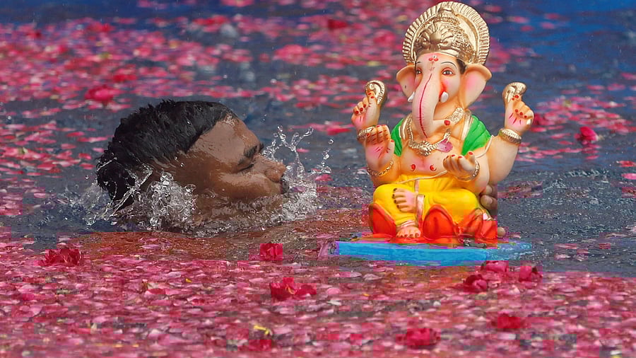 <div class="paragraphs"><p>A man immerses an idol of Ganesh during the ten-day-long Ganesh Chaturthi festival in Mumbai. </p></div>
