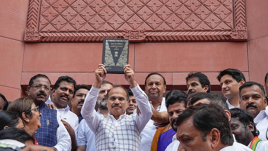 <div class="paragraphs"><p>Congress MP Adhir Ranjan Chowdhury, holding the Constitution of India, and other Parliamentarians walk towards the new Parliament building, in New Delhi.&nbsp;</p></div>
