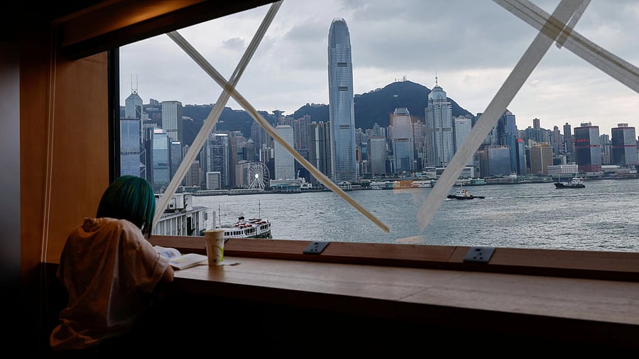 <div class="paragraphs"><p>A girl reads a book at a bookstore, where windows are taped in anticipation of typhoon Saola in Hong Kong, China.</p></div>