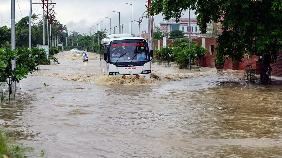 <div class="paragraphs"><p>Vehicles pass through a waterlogged road after heavy rains, in Gomti Nagar area in Lucknow. </p></div>