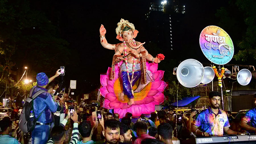 <div class="paragraphs"><p>Devotees transport an idol of Lord Ganesha during a procession ahead of Ganesh Chaturthi festival, in Mumbai.</p></div>