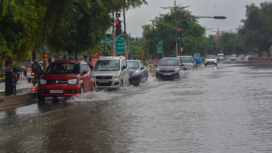 <div class="paragraphs"><p>Vehicles wade through a waterlogged road following heavy rains in Lucknow. </p></div>