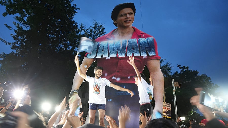 <div class="paragraphs"><p>Fans form a 'human pyramid' near a poster of Bollywood actor Shah Rukh Khan outside a cinema hall as they arrive to watch the screening of his latest film 'Jawan' at 6am, in Mumbai, Thursday, Sept. 7, 2023.</p></div>