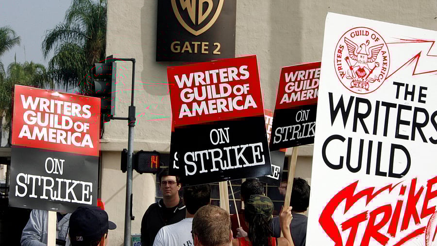 <div class="paragraphs"><p>Members of the Writers Guild of America carry picket signs.</p></div>