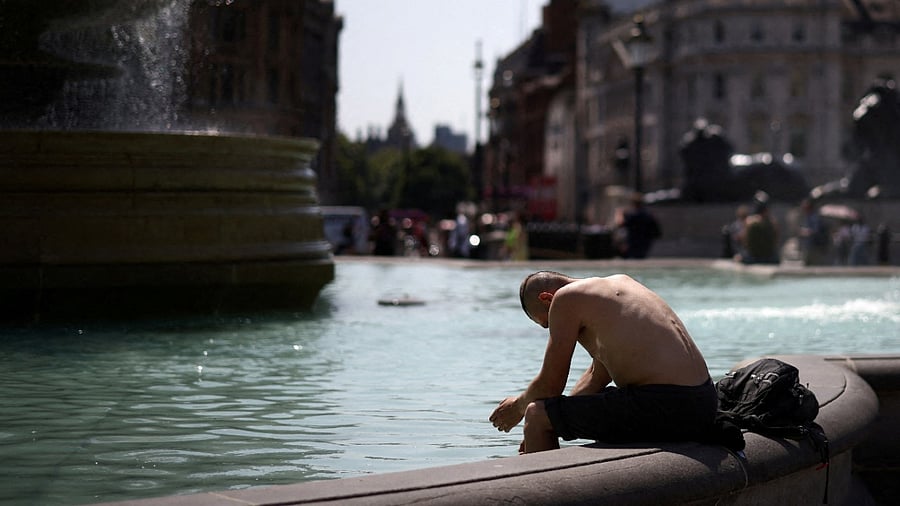 <div class="paragraphs"><p>A man cools off in a water fountain during a heatwave, at Trafalgar Square in London, Britain. </p></div>
