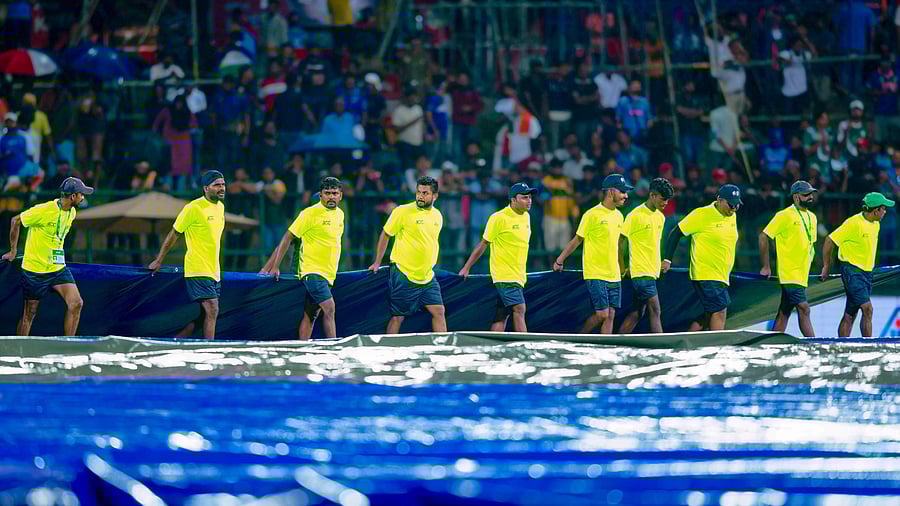 <div class="paragraphs"><p>Groundsmen cover the pitch as it rains during the Asia Cup match between India and Pakistan, at Pallekele International Cricket Stadium.</p></div>