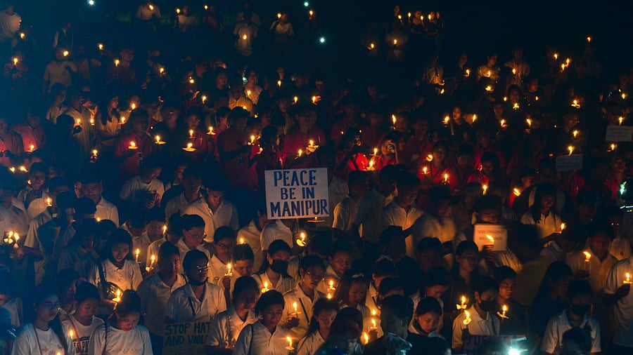<div class="paragraphs"><p> People holding placards and candles take part in a prayer service for peace in Manipur.</p></div>