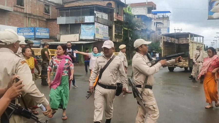 <div class="paragraphs"><p>Police try to control the situation as women stage a protest after unidentified miscreants burnt three houses, in Imphal, Sunday, Aug. 27, 2023.</p></div>