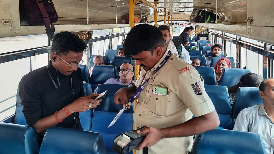 <div class="paragraphs"><p>A passenger pays money through UPI app to get a ticket in a NWKRTC bus. </p></div><div class="paragraphs"><p><br></p></div>