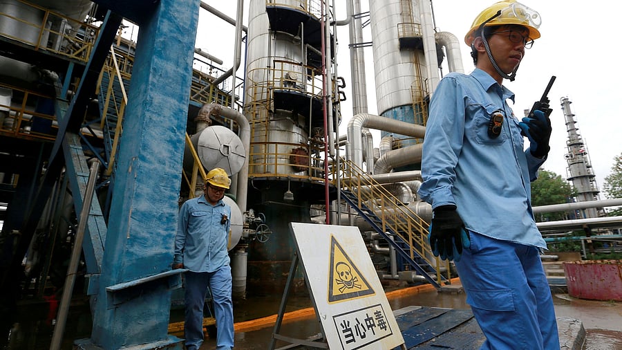 <div class="paragraphs"><p>FILE PHOTO: Technicians seen at a refinery that produces ethanol gasoline for vehicles, at China's Petroleum and Chemical Corporation, or Sinopec, Tianjin company, in Tianjin, China.</p></div>