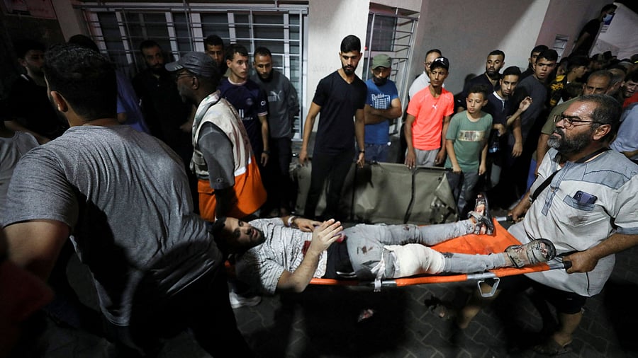 <div class="paragraphs"><p>An injured person is assisted at Shifa Hospital after an Israeli air strike hit the nearby Al-Ahli Hospital, according to Gaza Health Ministry in Gaza City, Gaza Strip, October 17, 2023.</p></div>