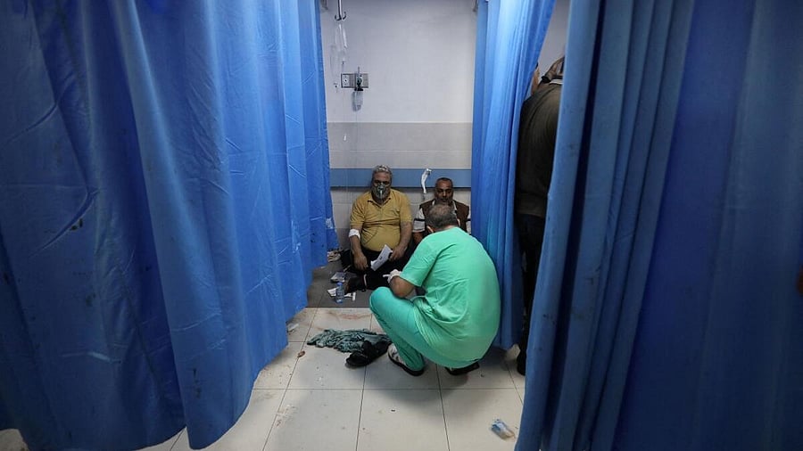 <div class="paragraphs"><p>People are assisted at Shifa Hospital after an Israeli air strike hit the nearby Al-Ahli Hospital, according to Gaza Health Ministry in Gaza City, Gaza Strip, October 17, 2023.</p></div>