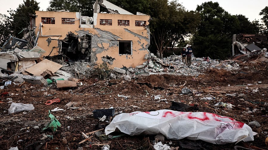 <div class="paragraphs"><p>A dead body lies on the ground following a mass infiltration by Hamas gunmen from the Gaza Strip, in Kibbutz Beeri in southern Israel, October 11, 2023.</p></div>