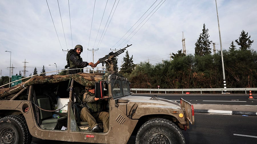 <div class="paragraphs"><p>Israeli soldiers ride in a military vehicle near Israel's border with Gaza, in southern Israel, October 11, 2023. </p></div>