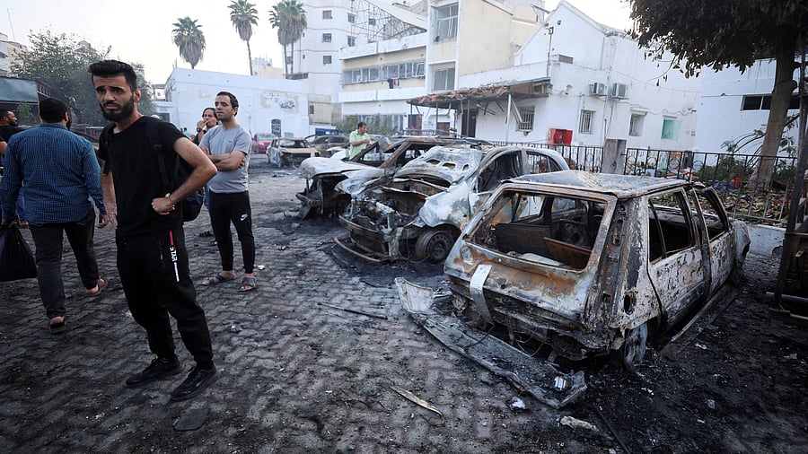 <div class="paragraphs"><p>People inspect the area of Al-Ahli hospital where hundreds of Palestinians were killed in a blast that Israeli and Palestinian officials blamed on each other, and where Palestinians who fled their homes were sheltering amid the ongoing conflict with Israel,  in Gaza City, October 18, 2023.  </p></div>