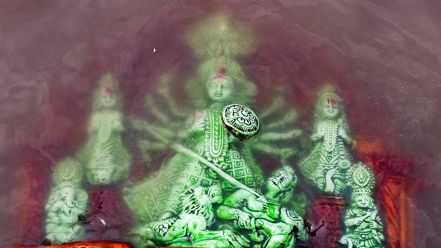 <div class="paragraphs"><p> An idol of goddess Durga being immersed (Visarjan) on the banks of river</p></div>