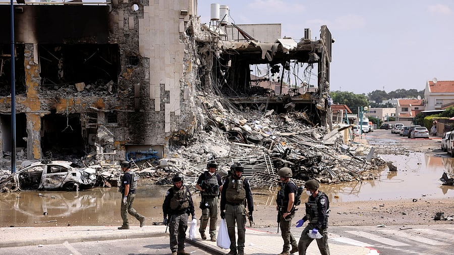 <div class="paragraphs"><p>Israeli security gather near a rifle at the site of a battle following a mass infiltration by Hamas gunmen from the Gaza Strip, in Sderot, southern Israel October 8, 2023. </p></div>