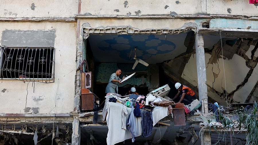 <div class="paragraphs"><p>Rescue workers move debris at the site of Israeli strikes on a house, amid the ongoing conflict between Israel and Palestinian Islamist group Hamas, in Khan Younis, southern Gaza Strip October 20, 2023.</p></div>