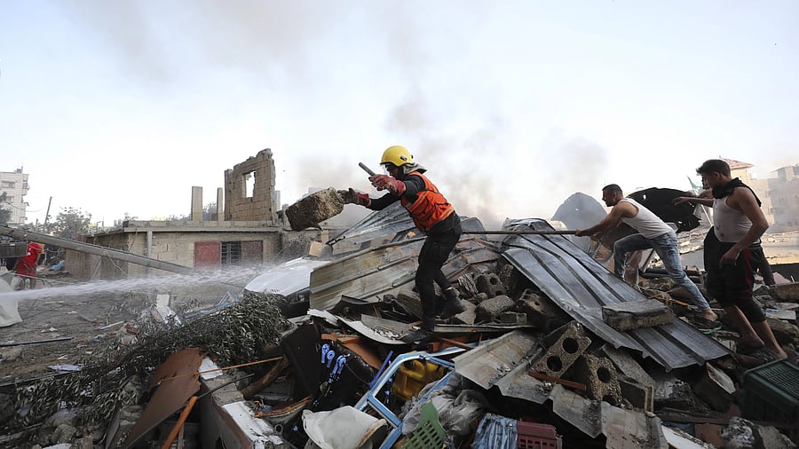 <div class="paragraphs"><p>Palestinians look for survivors after an Israeli airstrike on Nusseirat refugee camp, Gaza Strip, Wednesday, Oct. 18, 2023. </p></div>