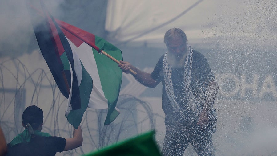 <div class="paragraphs"><p>A man holds a flag during a protest in support of Palestinians, near the US embassy in Awkar, after hundreds of Palestinians were killed in a blast at Al-Ahli hospital in Gaza that Israeli and Palestinian officials blamed on each other, Lebanon October 18, 2023.</p></div>