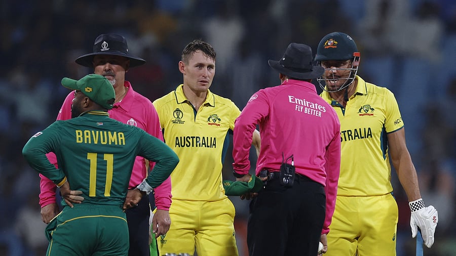 <div class="paragraphs"><p>Marcus Stoinis speaks to the umpire after losing his wicket, caught by South Africa's Quinton de Kock off the bowling of Kagiso Rabada as Marnus Labuschagne looks on.</p></div>