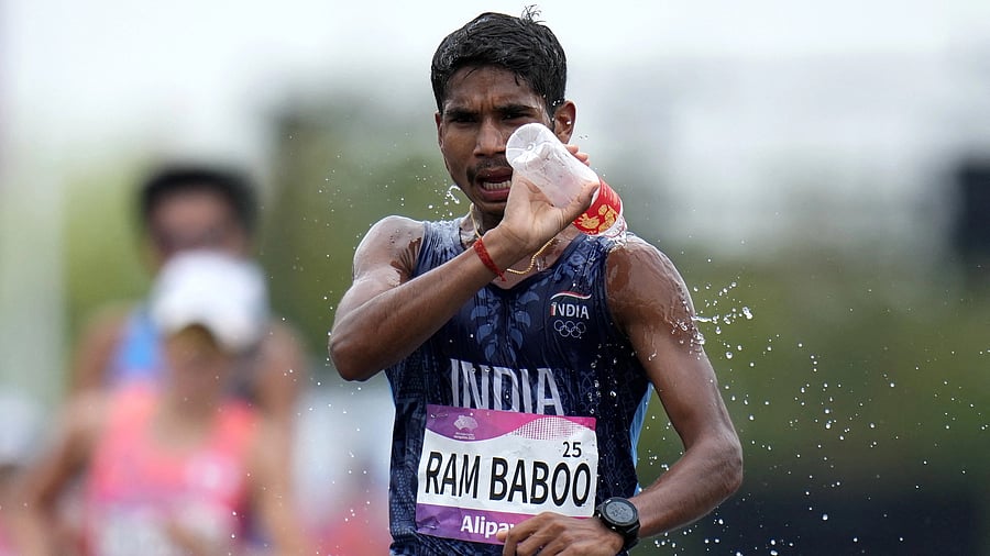 <div class="paragraphs"><p>Ram Baboo pours water over himself during the 35km Race Walk Mixed Team final.</p></div>