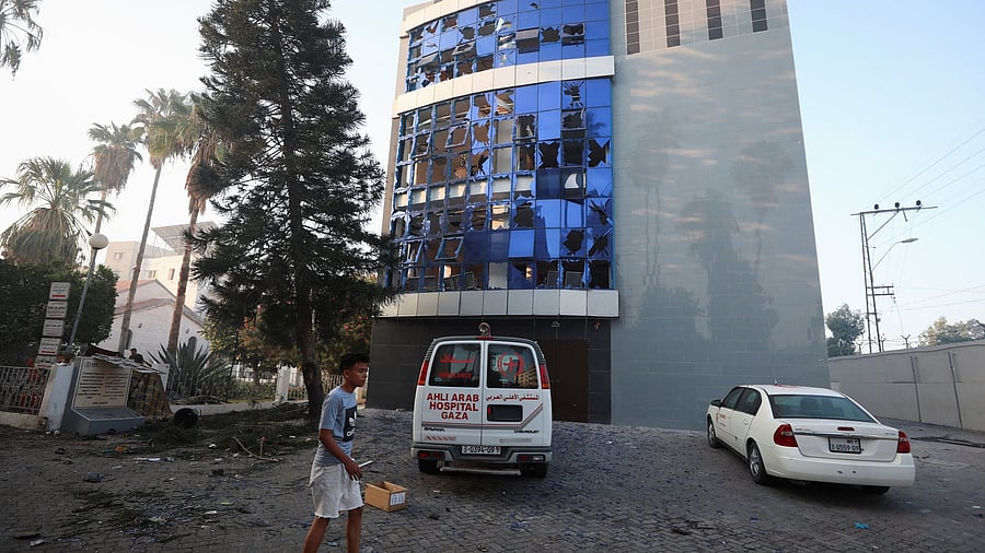 <div class="paragraphs"><p>A boy inspects the area of Al-Ahli hospital, where hundreds of Palestinians were killed in a blast that Israeli and Palestinian officials blamed on each other, in Gaza City.</p></div>