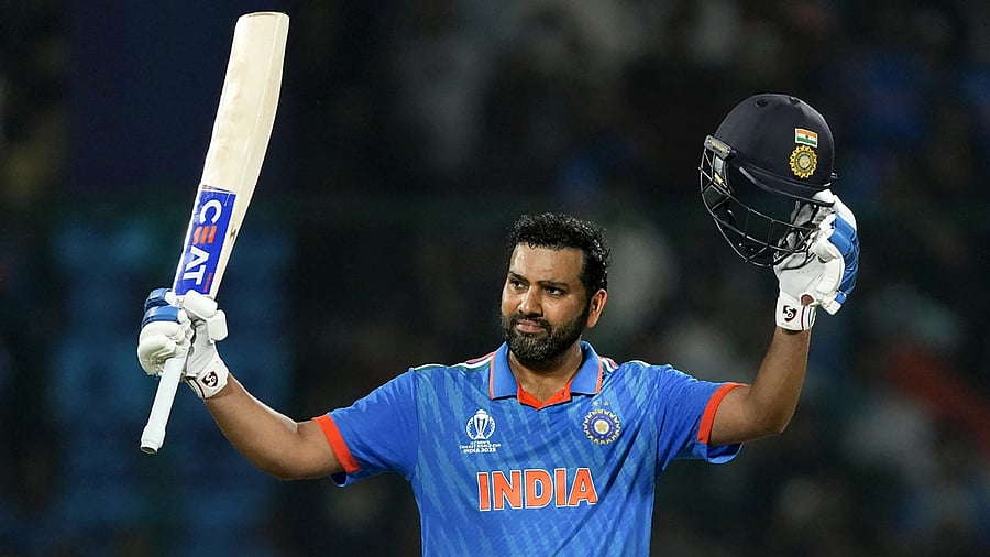 <div class="paragraphs"><p>Rohit Sharma raises his bat after scoring a century.</p></div>