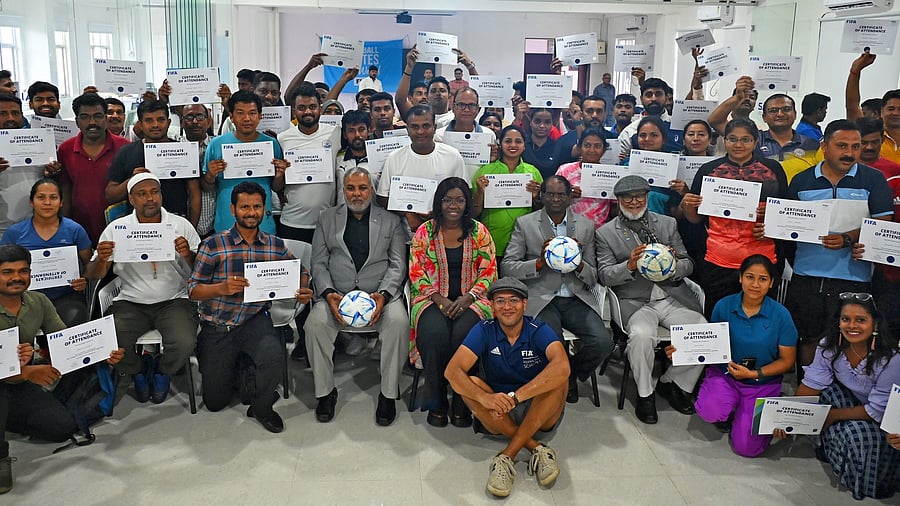 <div class="paragraphs"><p>FIFA Football for Schools Programme Director Fatimata Sow Sidibe (Centre, Sitting) and Amlan Kamal (Kneeling) strike a happy pose after the FIFA Football for Schools Capacity Building Workshop at SAI, Bengaluru on Friday. </p></div>
