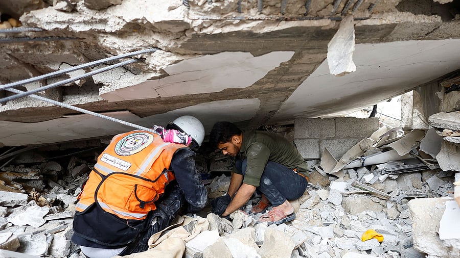 <div class="paragraphs"><p>An Emergency worker and a Palestinian man check the damage at the site of Israeli strikes on houses, amid the ongoing conflict between Israel and Palestinian Islamist group Hamas, in Khan Younis in the southern Gaza Strip.</p></div>