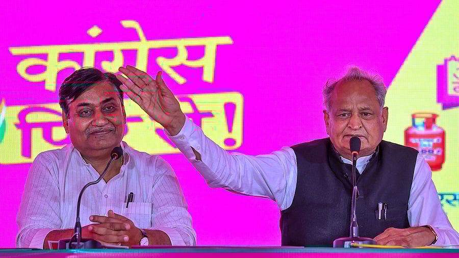 <div class="paragraphs"><p>Rajasthan Chief Minister Ashok Gehlot with Rajasthan Congress president Govind Singh Dotasra addresses a press conference during the launch of the party's 7 guarantees ahead of the state assembly elections, in Jaipur, Friday, Oct. 27, 2023. </p></div>