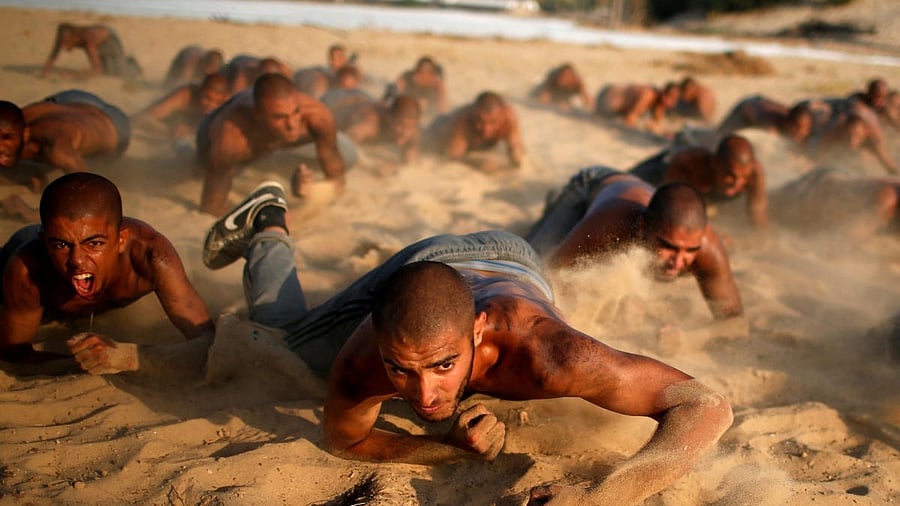 <div class="paragraphs"><p>Palestinian cadets crawl as they demonstrate their skills at a police college run by the Hamas-led interior ministry, in Khan Younis in the southern Gaza Strip.</p></div>