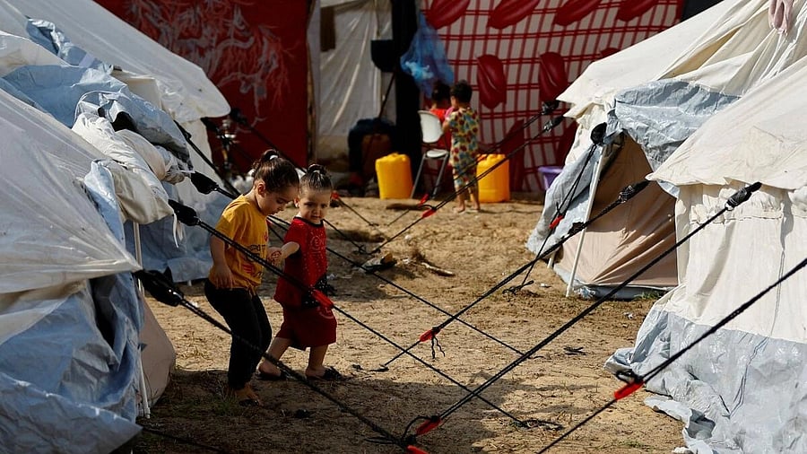 <div class="paragraphs"><p>Displaced Palestinian kids, who fled their houses amid Israeli strikes, take shelter in a tent camp at a United Nations-run centre, after Israel's call for more than 1 million civilians in northern Gaza to move south, in Khan Younis in the southern Gaza Strip, October 24, 2023.</p></div>