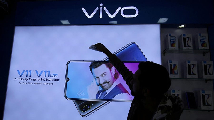 <div class="paragraphs"><p>A man cleans a screen displaying a phone model of Chinese smartphone maker Vivo inside a shop in Ahmedabad.</p></div>