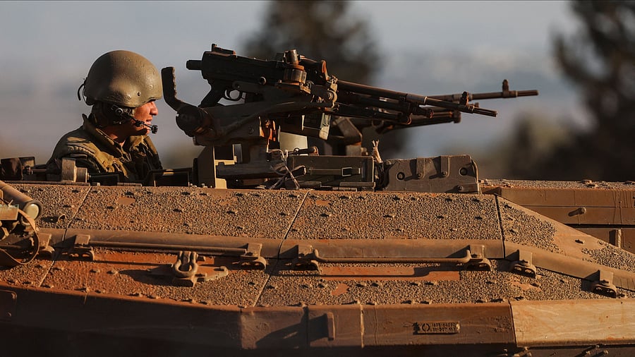 <div class="paragraphs"><p>An Israeli soldier looks out from a tank during a military drill near Israel's border with Lebanon in northern Israel, October 26, 2023. </p></div>