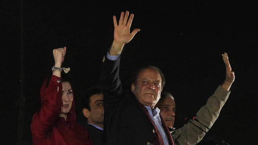<div class="paragraphs"><p>Pakistan's former Prime Minister Nawaz Sharif along with his brother, former Prime Minister Shehbaz Sharif, and daughter Maryam Nawaz Sharif, gestures to supporters upon his arrival from a self-imposed exile in London, ahead of the 2024 Pakistani general election.</p></div>
