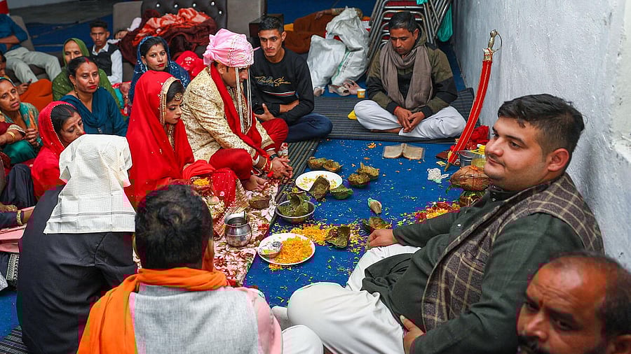 <div class="paragraphs"><p>People during a marriage ceremony at a community centre, even as Pakistan Rangers fired without provocation along the international border in Arnia sector of Jammu & Kashmir.</p></div>