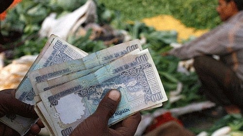<div class="paragraphs"><p>Representative image of Indian rupees and a vegetable vendor.</p></div>