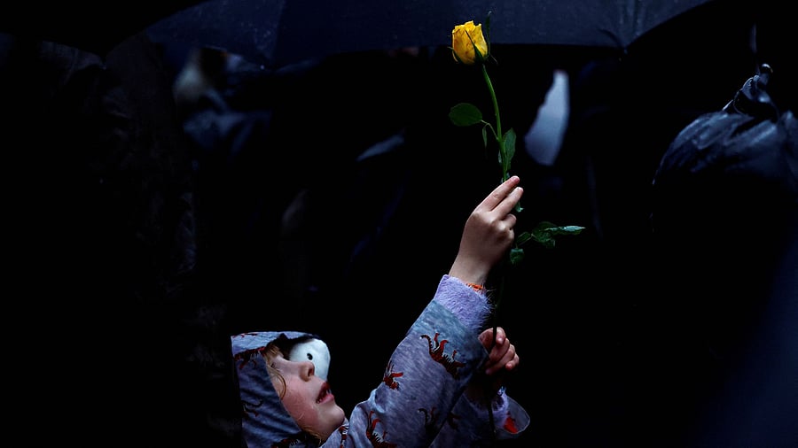 <div class="paragraphs"><p>Octavia Jeram, 6, holds up a yellow rose as demonstrators hold a vigil outside Downing Street in solidarity with Palestinians after the Al-Ahli hospital blast in Gaza, amid the ongoing conflict between Israel and the Palestinian Islamist group Hamas, in London, Britain, October 18, 2023.</p></div>