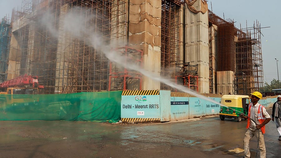 <div class="paragraphs"><p>A worker sprays water to curb air pollution at an under-construction building, at Sarai Kale Khan area in New Delhi.</p></div>