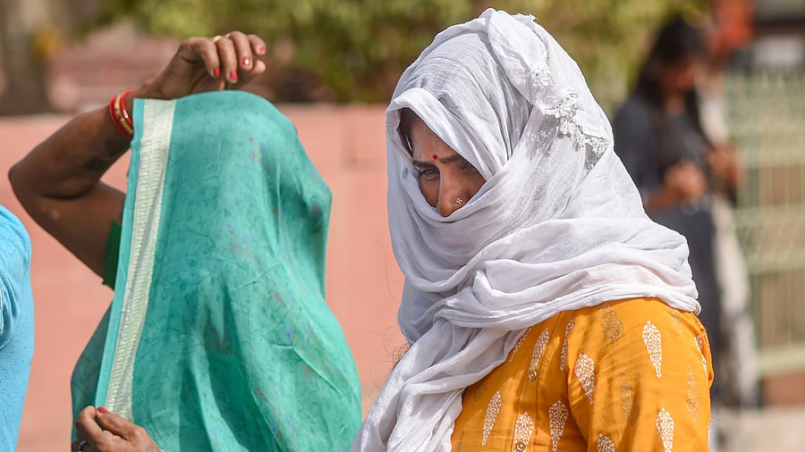<div class="paragraphs"><p>Women use scarves to shield themselves from the heat on hot summer afternoon.</p></div>