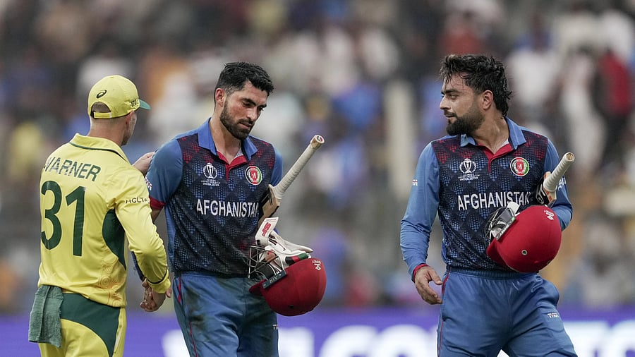 <div class="paragraphs"><p>Afghanistan's Ibrahim Zadran being congratulated by Australia's David Warner after the inning during the ICC Men's Cricket World Cup 2023 match between Afghanistan and Australia at the Wankhede Stadium, in Mumbai, Tuesday, Nov. 7, 2023. Afghanistan's Rashid Khan is also seen.</p></div>