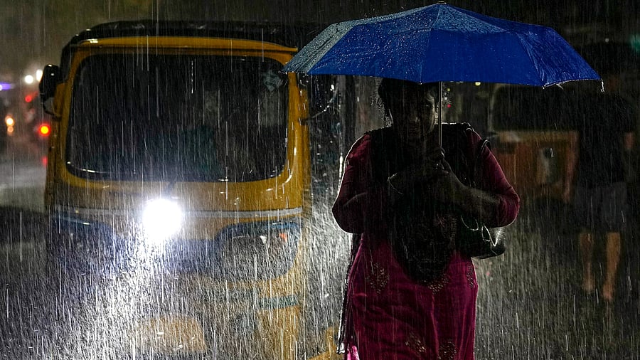 <div class="paragraphs"><p>Commuters make their way amid rain, in Chennai.</p></div>