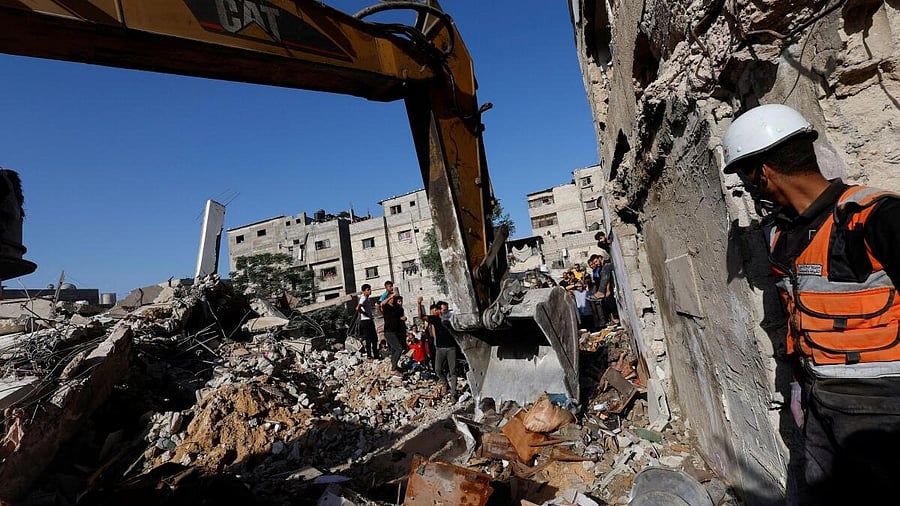 <div class="paragraphs"><p>Palestinians gather at the site of Israeli strikes on a residential building, amid the ongoing conflict between Israel and Palestinian Islamist group Hamas, in Khan Younis in the southern Gaza Strip, November 4, 2023.</p></div>