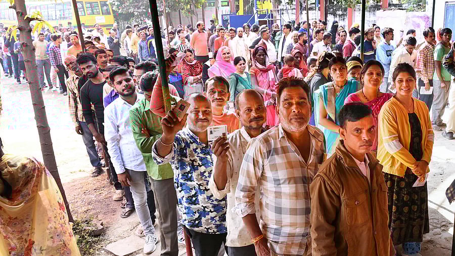 <div class="paragraphs"><p>Voters wait in queues at a polling station to cast their votes. </p></div>