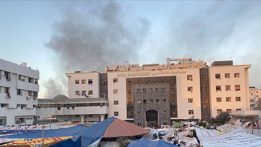 <div class="paragraphs"><p>Smoke rises as displaced Palestinians take shelter at Al Shifa hospital, amid the ongoing conflict between Hamas and Israel, in Gaza City.</p></div>