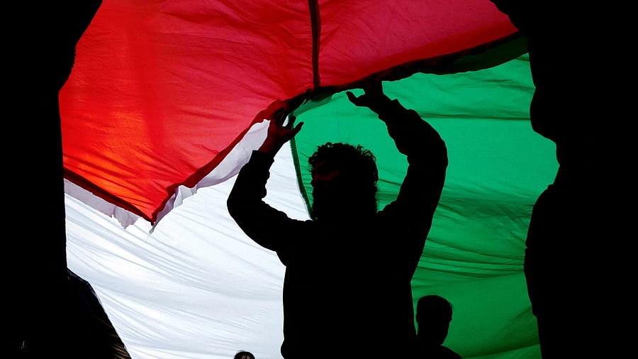 <div class="paragraphs"><p>People carry a Palestinian flag as they take part in a demonstration in solidarity with Palestinians in Gaza, amid the ongoing conflict between Israel and the Palestinian group Hamas.</p></div>